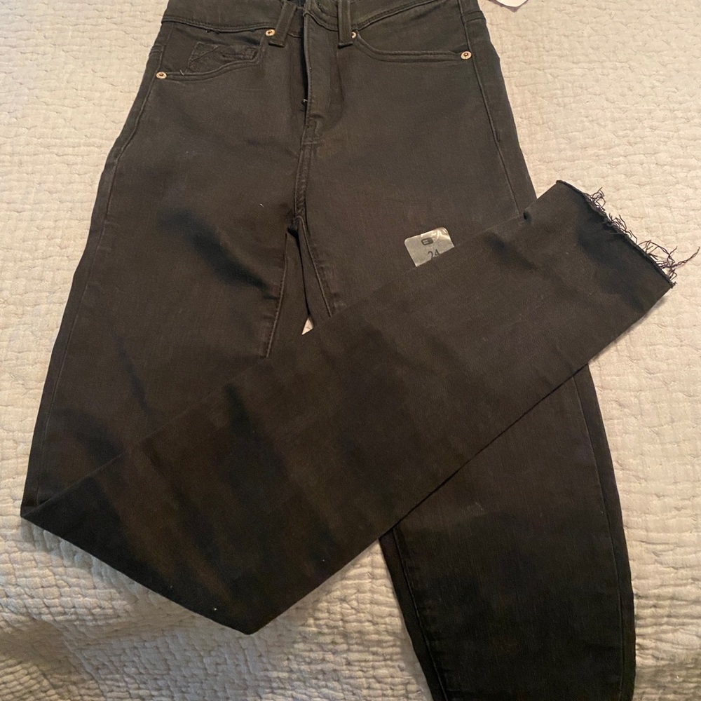 Women’s black buckle skinny jeans